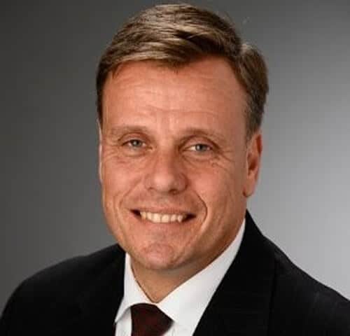 Trusted professional smiling in formal suit for business or corporate headshot.