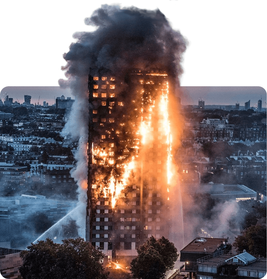 Burning skyscraper with flames and thick black smoke in a city skyline during daytime.